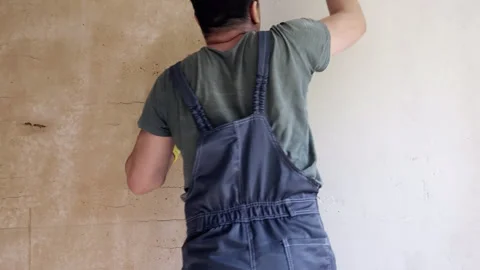 Worker applying putty to wall, time-lapse. Stock Footage 242185996