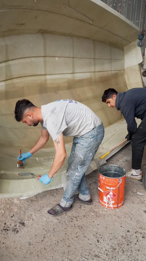 Worker Applying Resin to Composite Boat Hull, Turkey, Nov 19, 2025 Stock Footage 323180692
