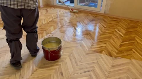A worker is applying a scraper polish to a parquet that has deteriorated. Stock Footage 244794767