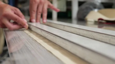 Worker applying sealant to metal window frames Stock Footage 338188540