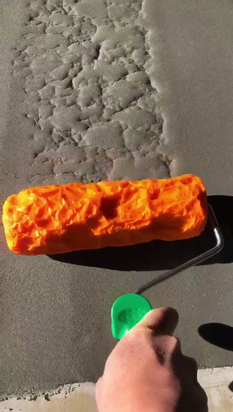 Worker applying texture roller on stamped concrete surface. stamped concret.. Stock Footage 303842563
