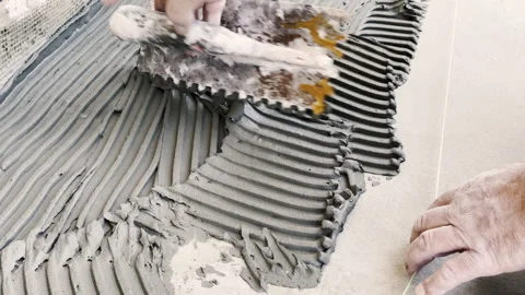 Worker Applying Tile Adhesive on a Floor – Construction and Tiling Work Vidéo 316849100