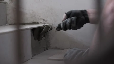 Worker applying tile adhesive on stair corner Stock Footage 320785712