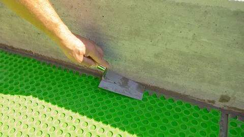 Worker Applying Waterproofing Membrane at Wall and Floor Junction Stock Photos