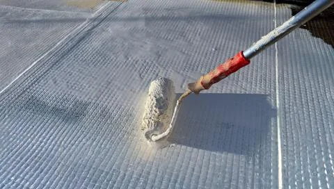 Worker Applying White Waterproofing Membrane With Paint Roller Stock Photos