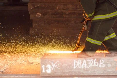 Worker are peeling the slab surface, Steel industry background. Stock Photos