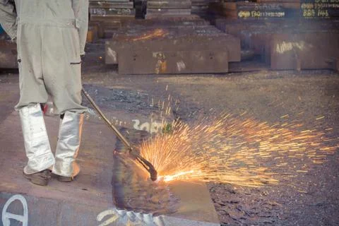 Worker are peeling the slab surface, Steel industry background. Stock Photos