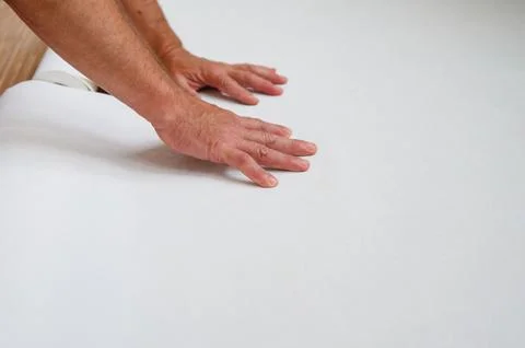 Worker are preparing wallpaper for hanging. Stock Photos