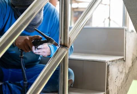 Worker argon welding rail. Stock Photos