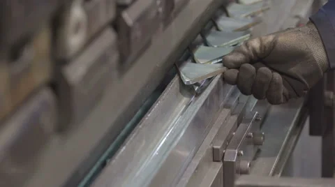 A worker arranging the small triangle metals Stock Footage 60627897