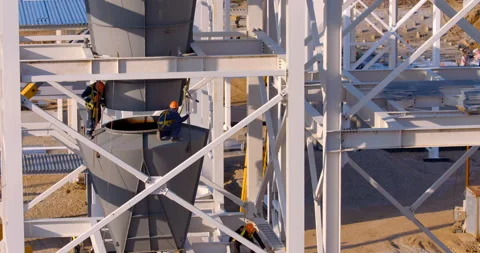 Worker assemblers at a height assemble industrial equipment  Stock Footage 161991800