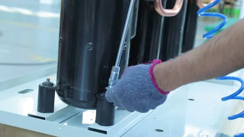 Worker assembles an air conditioner compressor Stock Footage 162904185