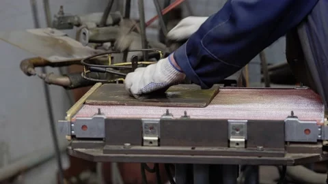 A worker assembles a copper radiator at the enterprise Stock Footage 213719379