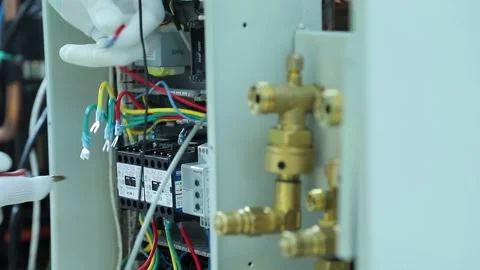 Worker assembles elements of an electrical panel Stock Footage 162904324