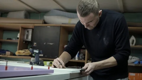 A worker assembles furniture Stock Footage 88177451