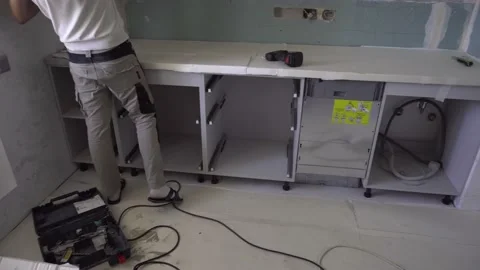 Worker assembles the kitchen. Contractor at work. Stock Footage 157288535