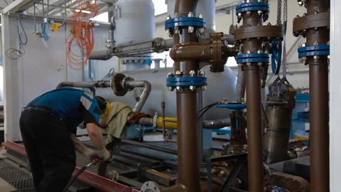 Worker assembles Oil and Gas equipment in industrial plant. The group metering Stock Footage 127520927