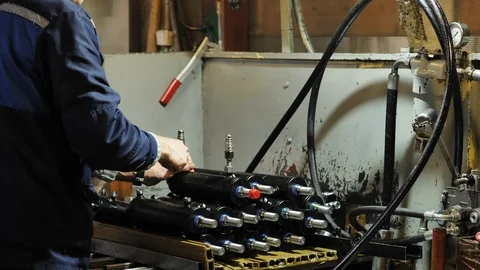 Worker assembles pneumatic piston, Production of hydraulic cylinders Stock Footage 107832381