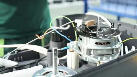 Worker assembles a semi-automatic washing machine Stock Footage 162903788