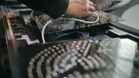 Worker assembles traffic light microcircuits at the production site. Close-up Stock-Footage 137579898