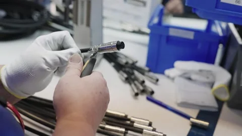 Worker assembling cable connectors in a Modern Technology Production Facility Stock Footage 319503926