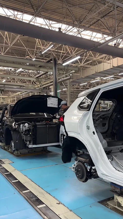 Worker Assembling Car Engine on Production Line in a Chinese Factory Stock Footage 336838911