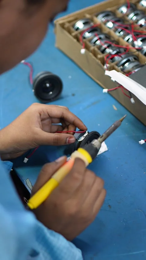Worker Assembling Electronic Speaker Components in Noida Factory Stock Footage 345809998