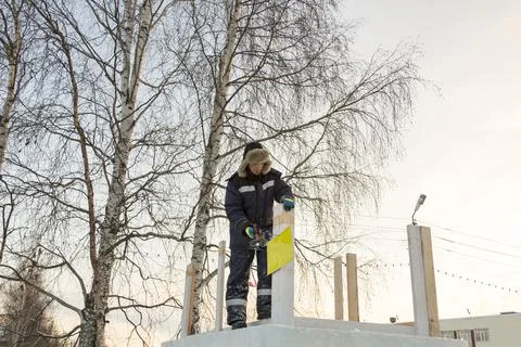 Worker assembling the frame of a wooden slide 写真素材