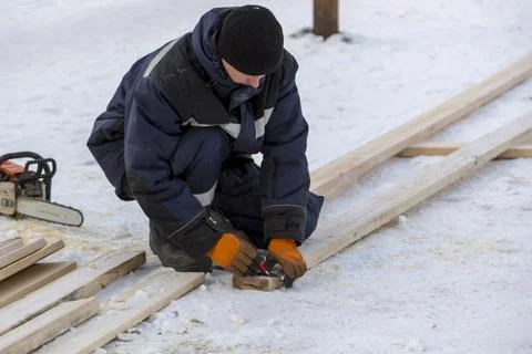 Worker assembling the frame of a wooden slide Fotos Stock