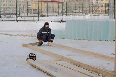 Worker assembling the frame of a wooden slide 스톡 사진