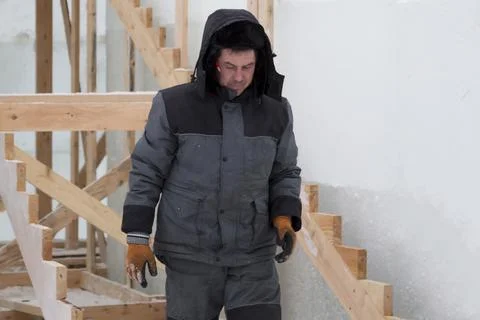 Worker assembling the frame of a wooden slide 스톡 사진