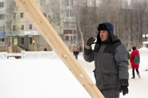 Worker assembling the frame of a wooden slide 写真素材