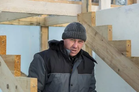 Worker assembling the frame of a wooden slide 写真素材