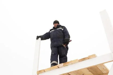Worker assembling the frame of a wooden slide 스톡 사진