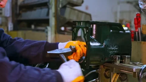 Worker Assembling Industrial Machine Component in Workshop Stock Footage 308043303