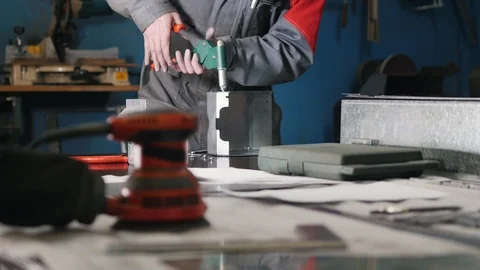 Worker assembling the metal part by hand with pliers, tools for grinding metal Stock Footage 86930079