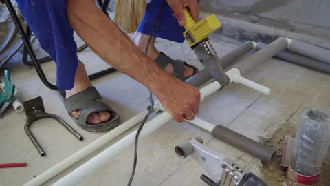 Worker assembling plastic pipes with welding tool Stock Footage 312346261