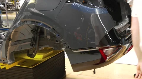 Worker Assembling Rear Section of Car on Production Line Video stock 346228251