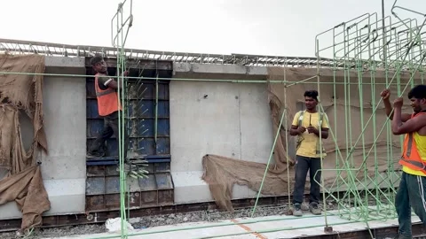 Worker is assembling a reinforcing steel cage for pouring concrete on a bridge Stock Footage 336942729
