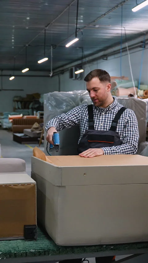 Worker Assembling Sofa Frame in Upholstery Workshop Stock Footage 305616122