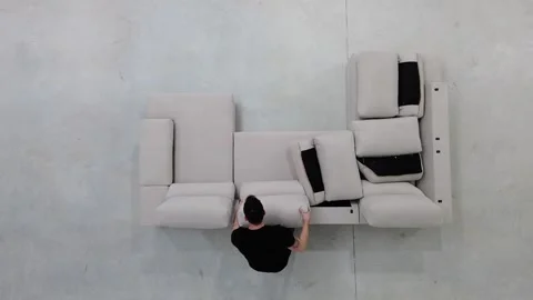Worker assembling sofa, placing cushions and fluffing them Vídeos de archivo 300192268