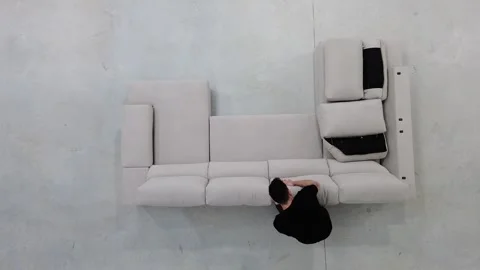 Worker assembling sofa, placing cushions and fluffing them Stock-Footage 300193601