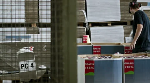 Worker on assembly line picking up salt packages and boxing them Stock-Footage 25930008