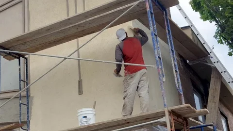 Worker Atop saffolding Applying Stucco Historic Movie Theater Restoration Stock Footage 79776046