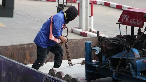 A worker attaches chains from a crane Stock Footage 214229315