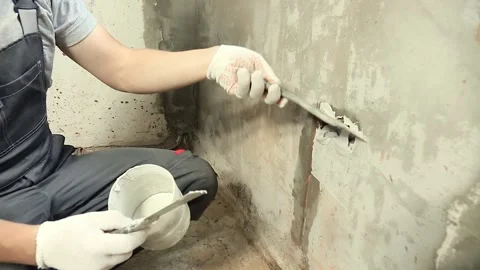 A worker attaches to the wall socket box using gypsum plaster. Stock Footage 148274420