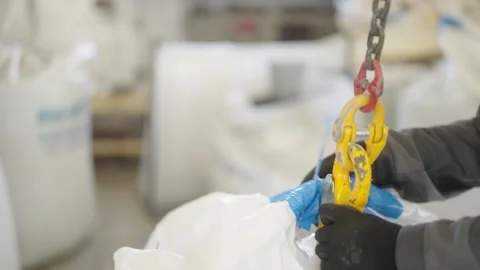 Worker attaching crane hook to industrial load, cargo works. Stock Footage 274490397