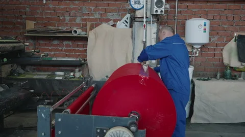 Worker Attaching Duct Tape To Eco Fabric Roll On Industrial Processing Machine Stock Footage 203892072