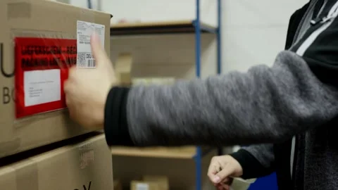 Worker Attaching a Packing List Pouch to a Cardboard Box, Close Up Shot Stock-Footage 341433820