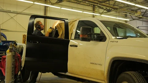 Worker in an automative welding shop fixing a truck.  Stock Footage 89956971